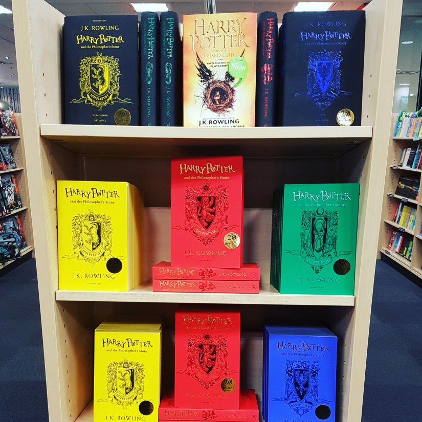 Harry Potter house editions displayed on a shelf in a bookstore